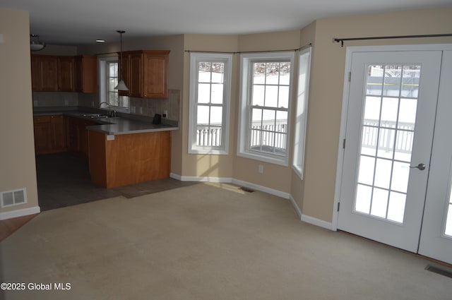 kitchen with pendant lighting, plenty of natural light, and decorative backsplash