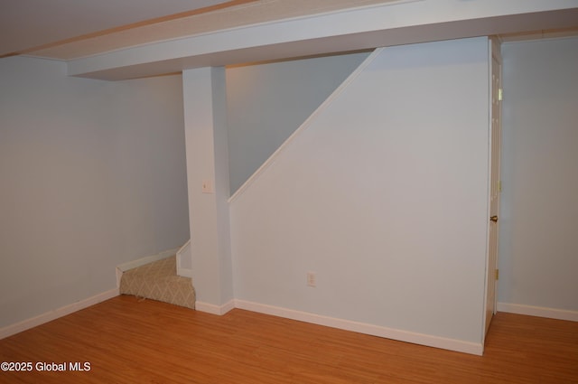 basement with light hardwood / wood-style flooring