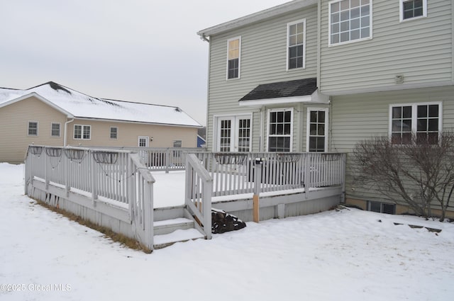 snow covered rear of property featuring a wooden deck