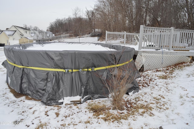 yard covered in snow with a wooden deck