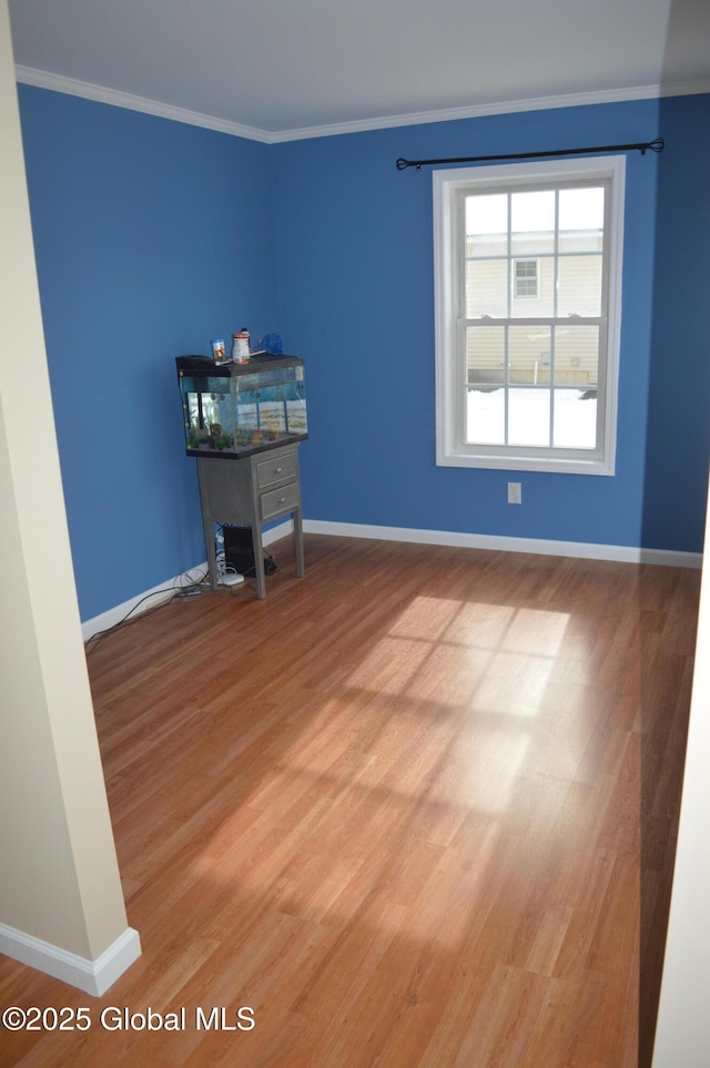 unfurnished room with hardwood / wood-style floors and ornamental molding