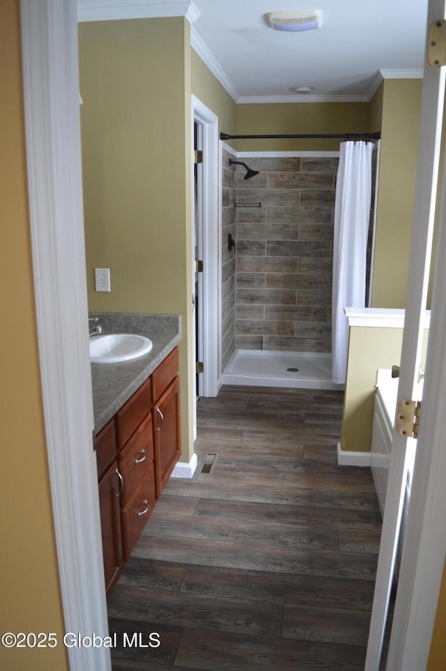 bathroom featuring ornamental molding, vanity, separate shower and tub, and hardwood / wood-style floors