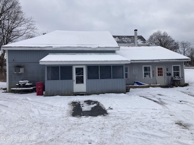 snow covered property featuring a wall mounted AC