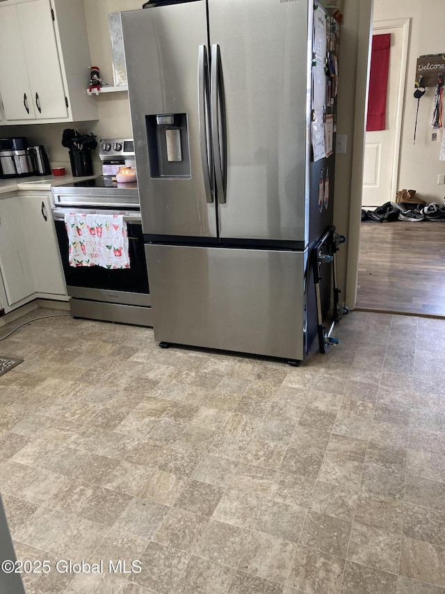 kitchen with open shelves, appliances with stainless steel finishes, and white cabinets