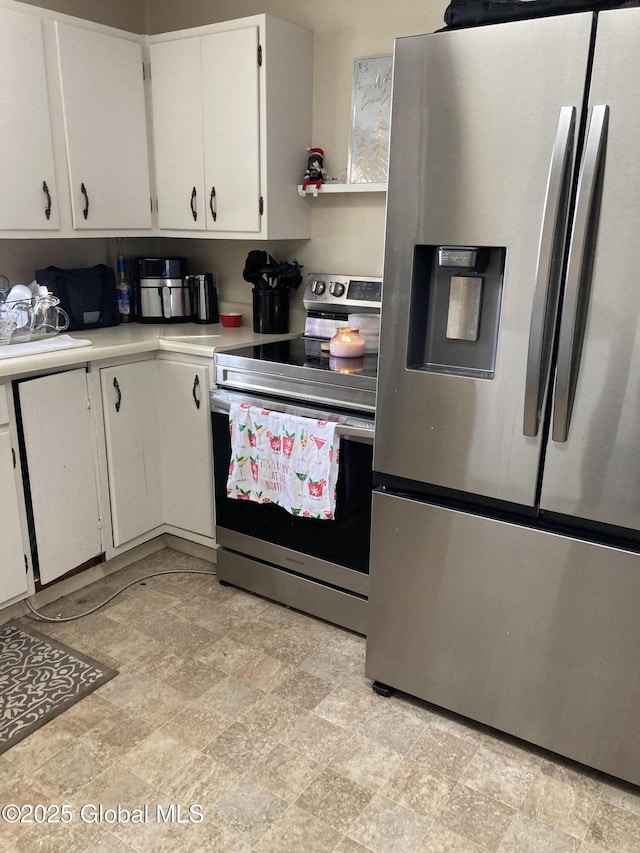 kitchen with appliances with stainless steel finishes, light countertops, and white cabinets