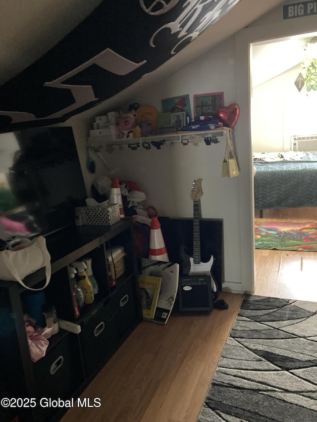 interior space featuring lofted ceiling and wood finished floors