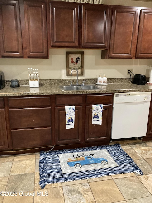 kitchen with a sink, dark countertops, and dishwasher