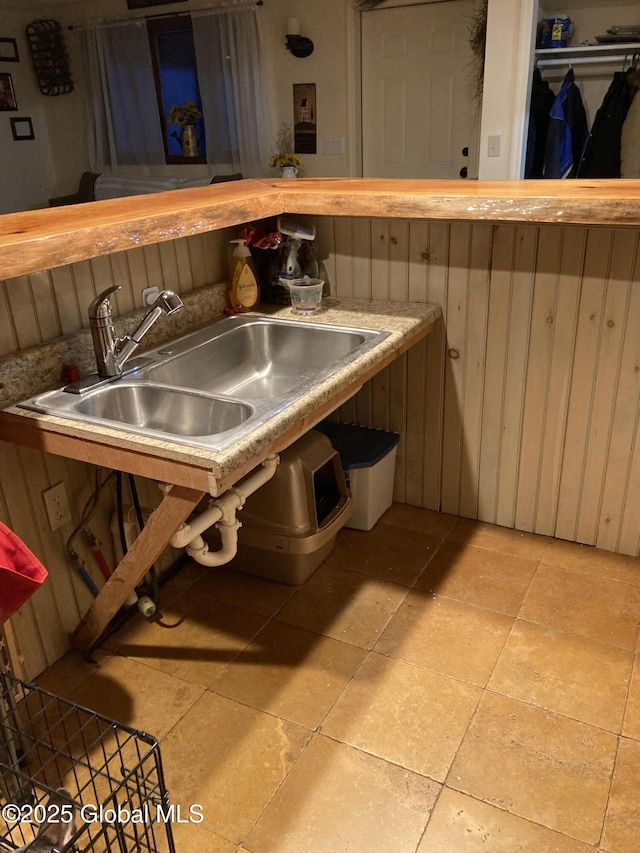 interior space with a sink and light tile patterned flooring