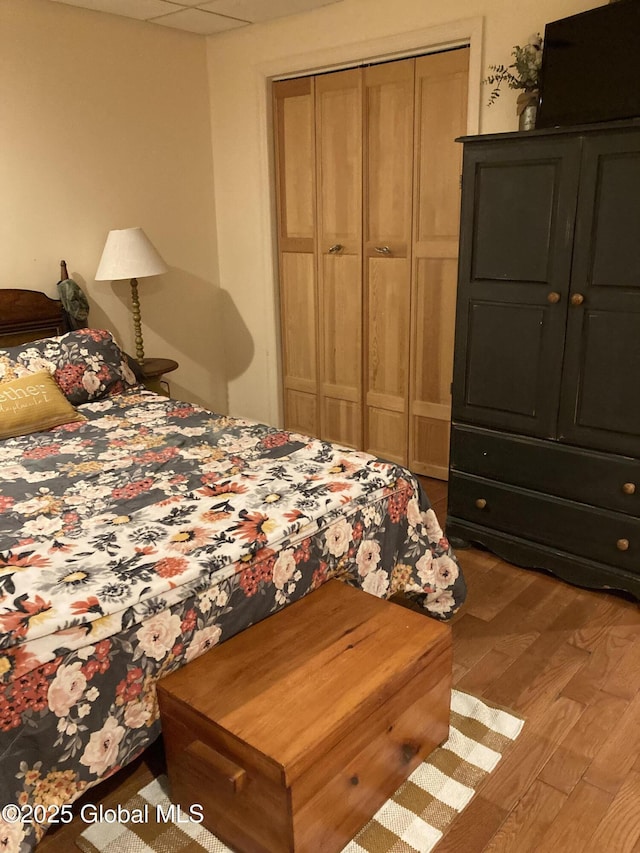 bedroom featuring a closet and wood finished floors