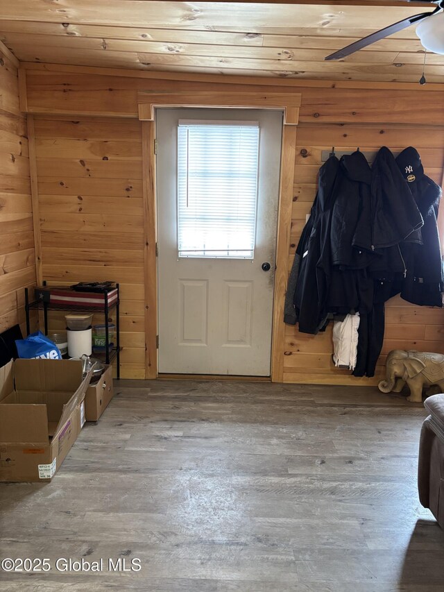 86 Reid St, Fort Plain, NY 13339 - doorway with wood finished floors, wood walls, and ceiling fan