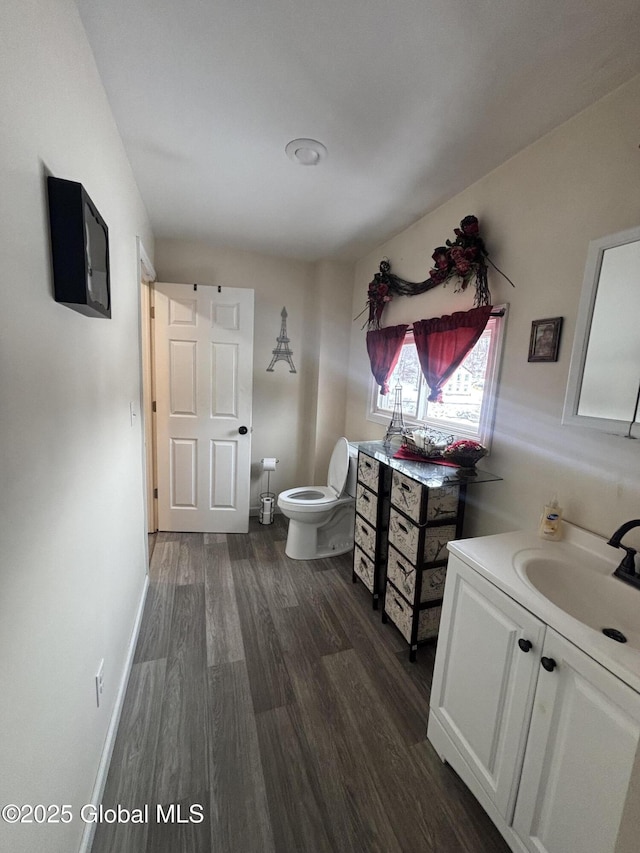 86 Reid St, Fort Plain, NY 13339 - half bath featuring toilet, vanity, baseboards, and wood finished floors