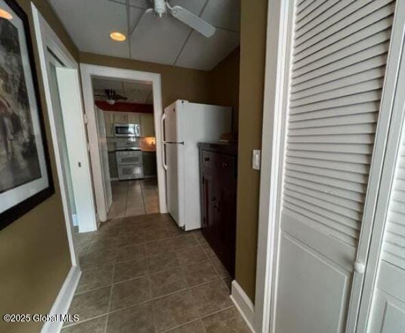 hallway featuring dark tile patterned flooring