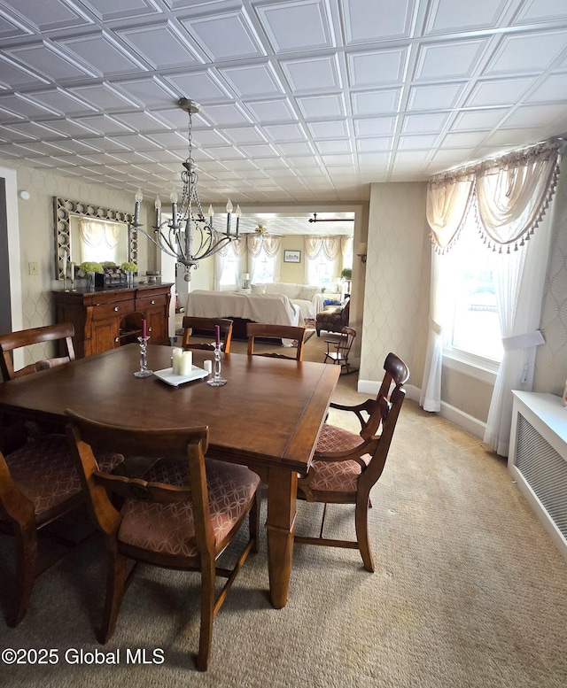 carpeted dining room featuring a healthy amount of sunlight