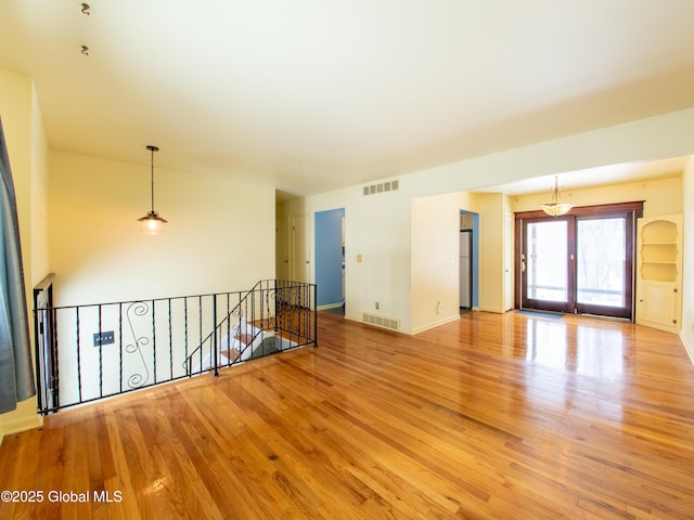 unfurnished room with light wood-type flooring and french doors