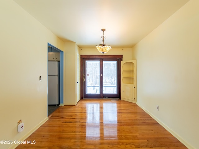 interior space with light hardwood / wood-style floors and french doors