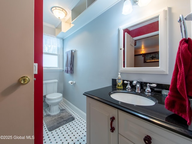 bathroom with toilet, crown molding, and vanity