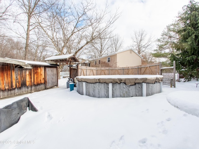 snowy yard with a covered pool