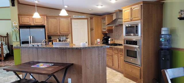 kitchen with stainless steel appliances, a kitchen island, lofted ceiling, and wall chimney exhaust hood