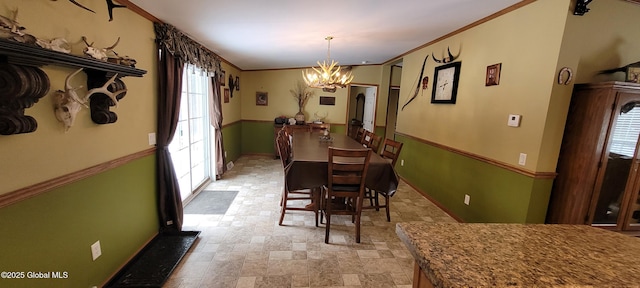 dining area with an inviting chandelier and ornamental molding