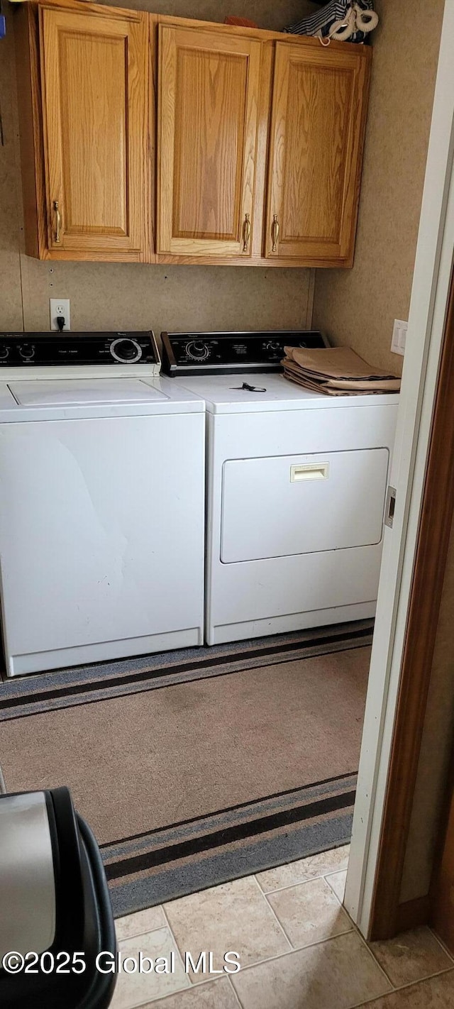 washroom with cabinets and independent washer and dryer