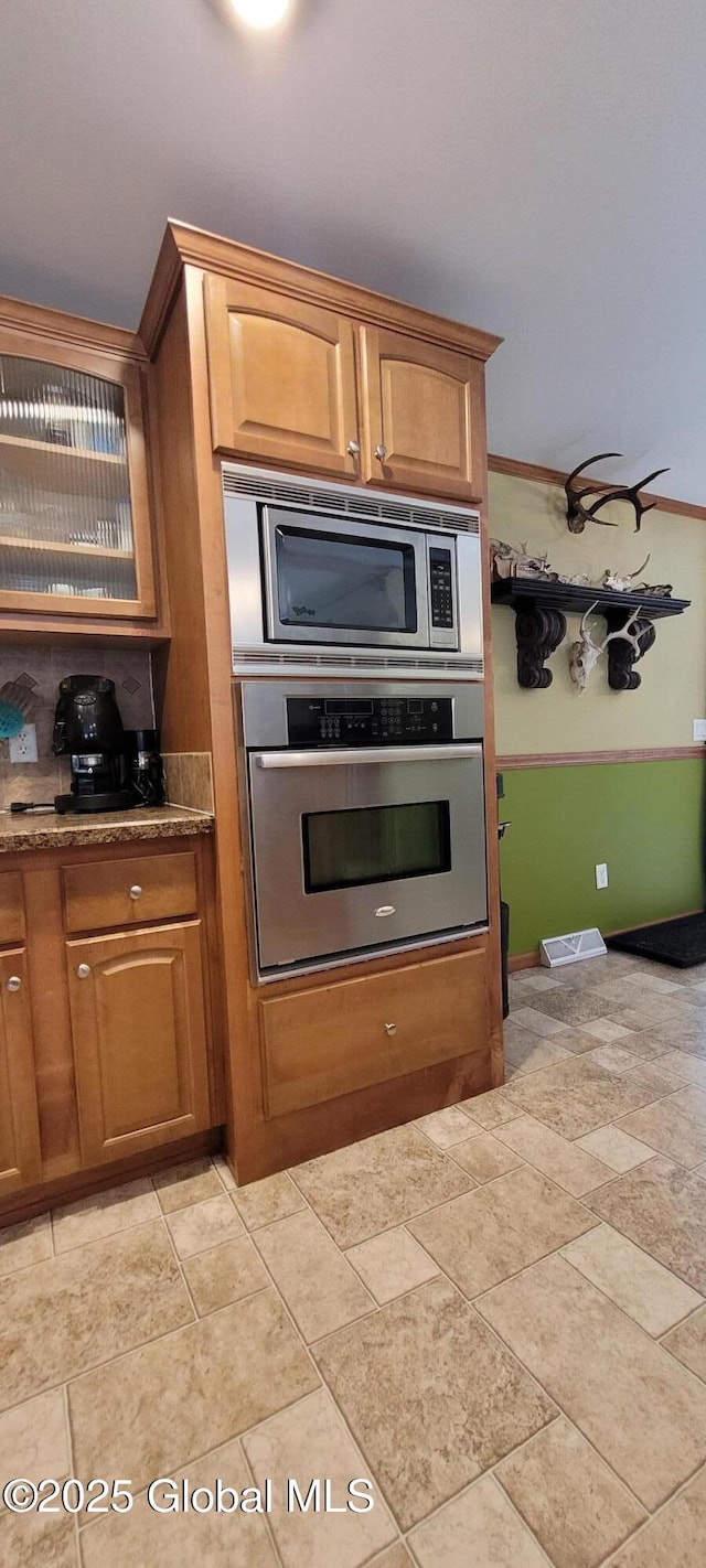 kitchen featuring stainless steel appliances and ornamental molding