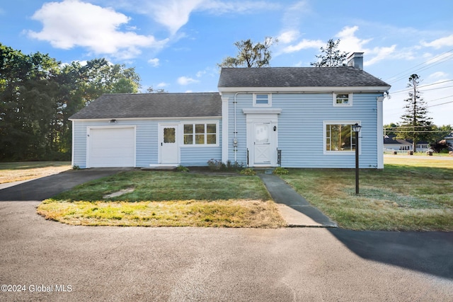 view of front of house with a garage and a front yard