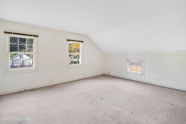 bonus room featuring lofted ceiling and carpet floors