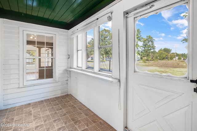 unfurnished sunroom featuring wood ceiling