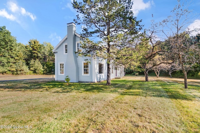 view of home's exterior with a lawn