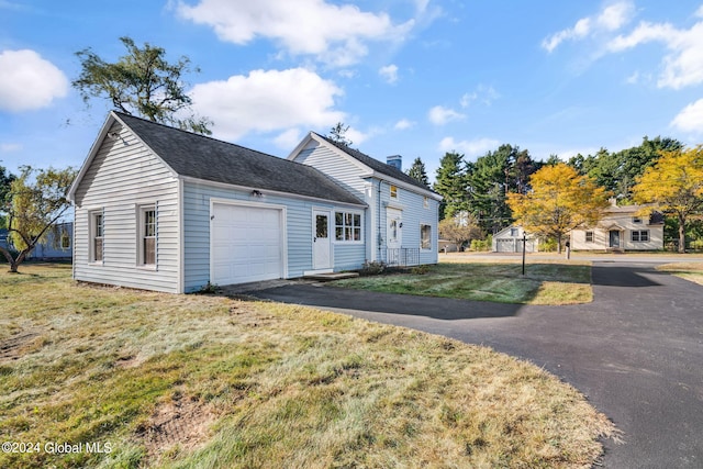 view of front facade with a garage and a front lawn