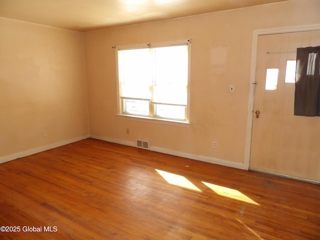 unfurnished room featuring hardwood / wood-style floors