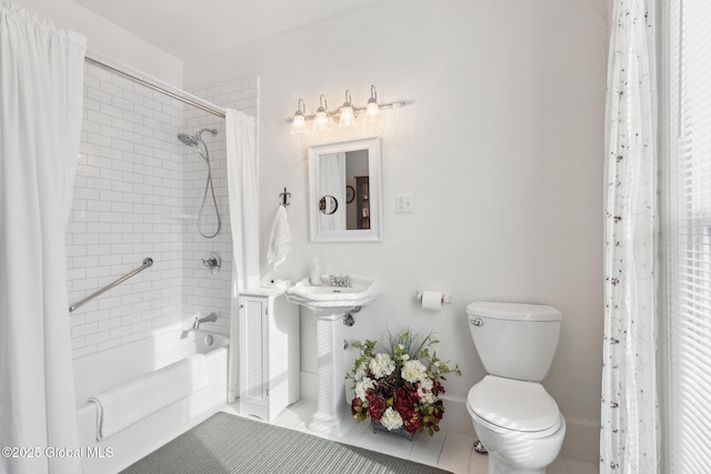 bathroom featuring tile patterned floors, toilet, and shower / tub combo