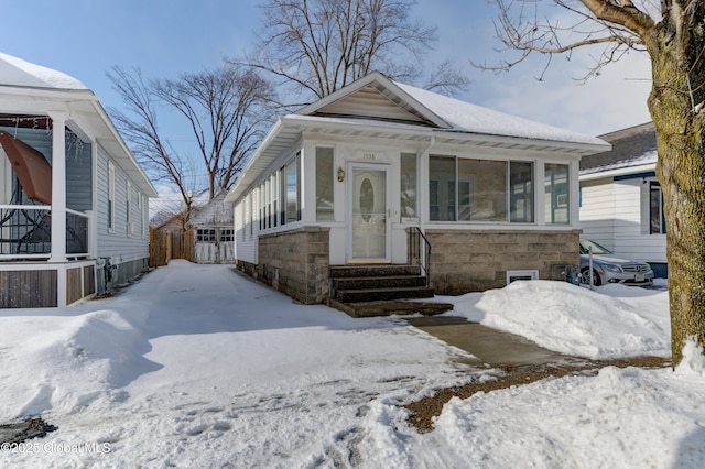 bungalow-style house with a sunroom