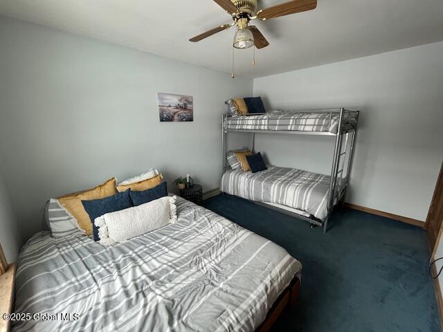 bedroom with ceiling fan and dark colored carpet