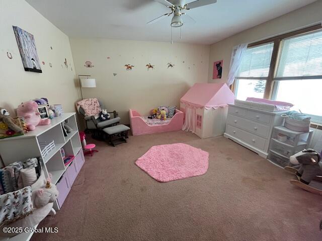 playroom featuring light colored carpet and ceiling fan