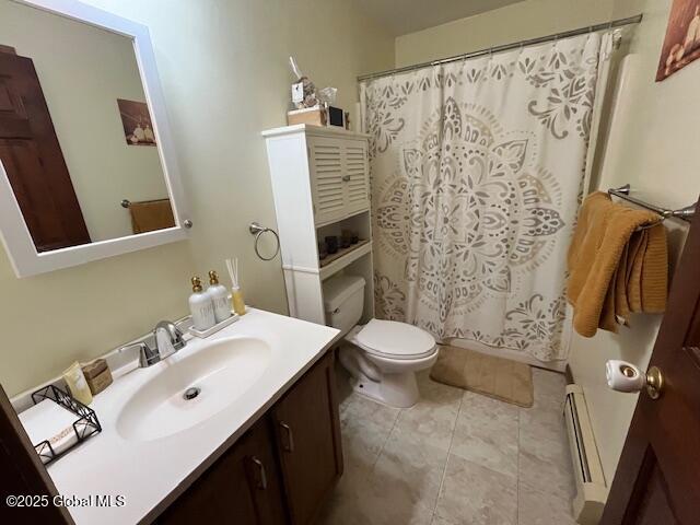 bathroom with vanity, a shower with curtain, a baseboard radiator, tile patterned floors, and toilet