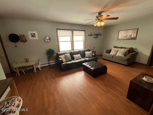 living room featuring wood-type flooring and ceiling fan