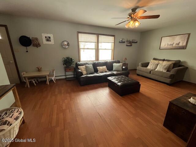 unfurnished living room with hardwood / wood-style flooring and ceiling fan