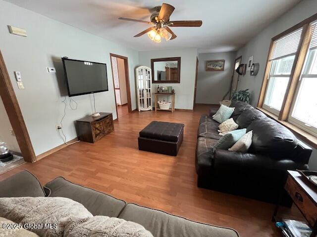 living room featuring hardwood / wood-style flooring and ceiling fan