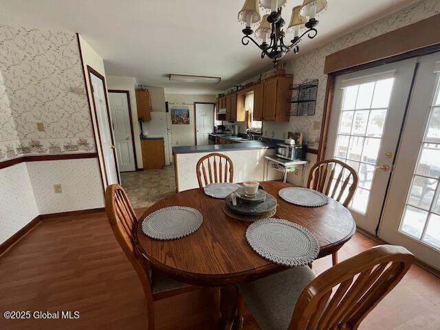 dining room with hardwood / wood-style flooring and a notable chandelier