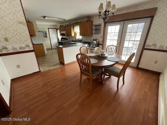 dining room with hardwood / wood-style flooring, a chandelier, and a healthy amount of sunlight