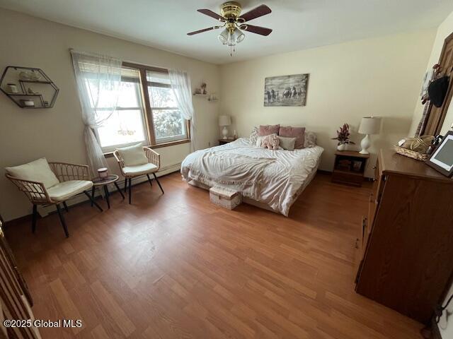 bedroom featuring ceiling fan and hardwood / wood-style floors