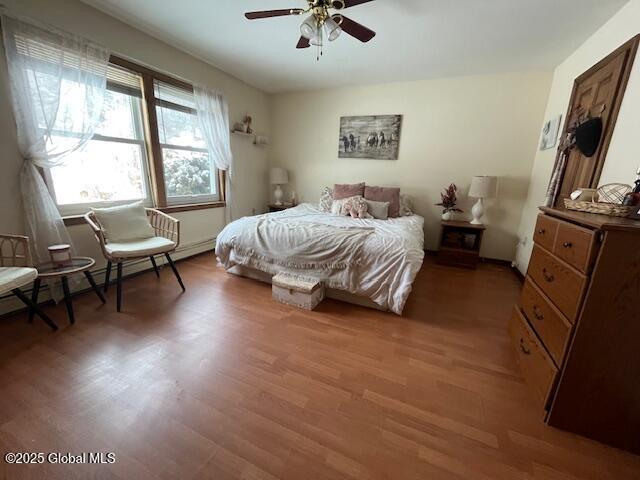 bedroom featuring ceiling fan and light wood-type flooring