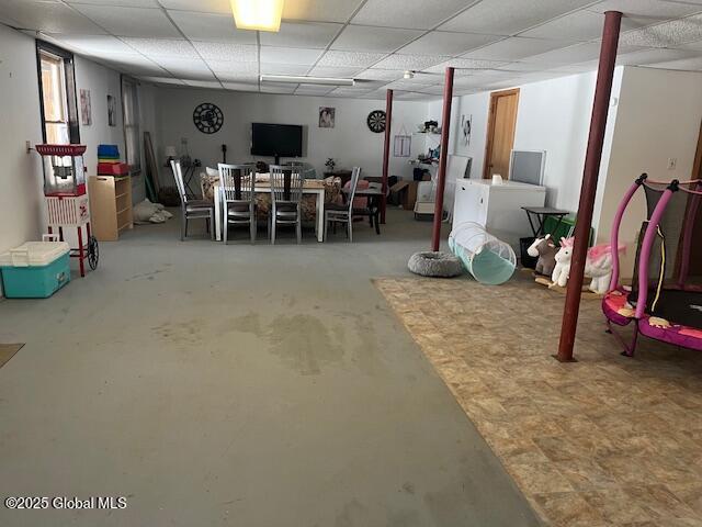 basement featuring a paneled ceiling