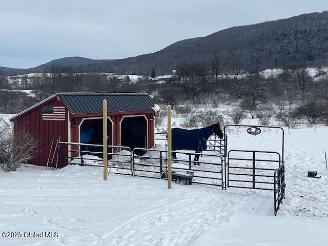 view of stable featuring a mountain view