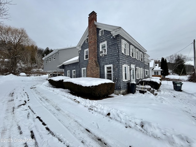 snow covered property featuring cooling unit