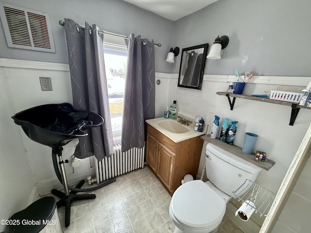 bathroom featuring vanity, radiator, and toilet