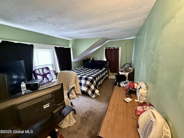 bedroom with lofted ceiling, carpet floors, and a textured ceiling