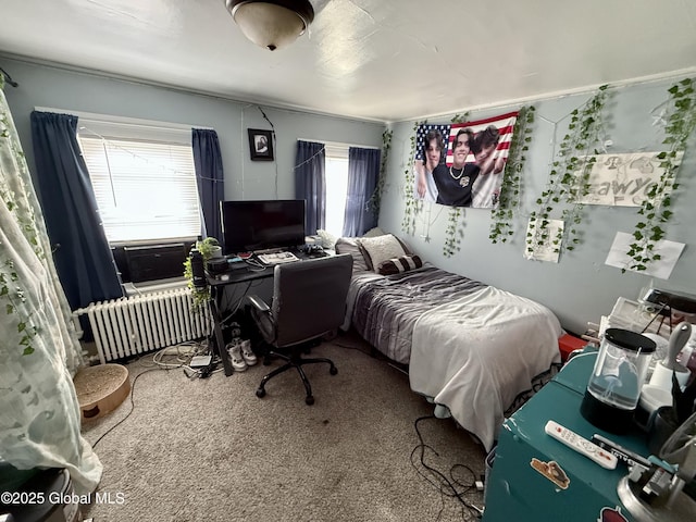 bedroom featuring multiple windows, radiator, cooling unit, and carpet