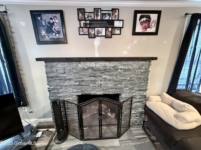 interior details featuring a fireplace and ornamental molding